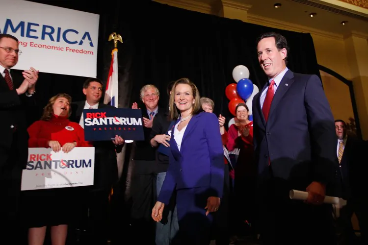 Republican presidential candidate, former Sen. Rick Santorum (R) takes the stage with his wife Karen during a primary election night party, Feb. 7, at the St. Charles Convention Center in St. Charles, Missouri. (Whitney Curtis/Getty Images)