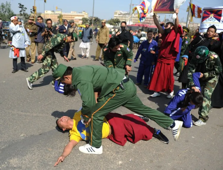 Tibetans in-exile take part in a mock protest in New Delhi on February 8, 2012, denouncing clashes between Chinese police and Tibetans in China's southwestern province of Sichuan. (Sajjad Hussain/AFP/Getty Images)