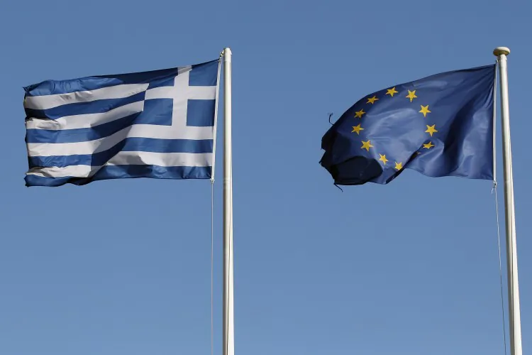 A Greek and an EU flag fly outside the Acropolis Museum on February 19, in Athens, Greece. (Oli Scarff/Getty Images)