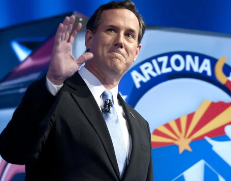Republican presidential candidate Rick Santorum waves as he arrives to the debate hall on Feb. 22 in Mesa, Ariz. According to a Quinnipiac University Poll, Rick Santorum emerged the front-runner among the Republican presidential candidates with 35 percent, compared to former Massachusetts Gov. Mitt Romney with 26 percent. (Don Emmert/AFP/Getty Images)