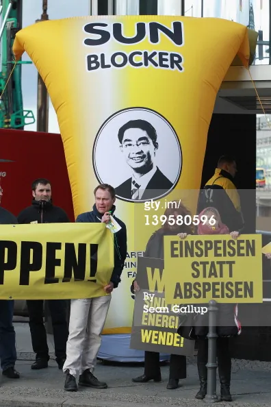 Activists protesting cuts in subsidies to solar power in Germany and holding signs showing German Economy Minister Philipp Rösler on Feb. 23, in Berlin, Germany. The German government has announced a reduction in subsidies for solar energy. (Sean Gallup/Getty Images)