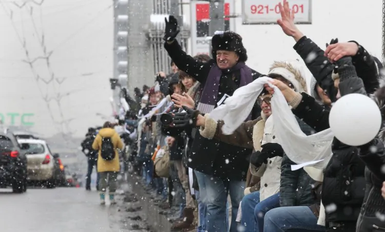 Russian opposition supporters, holding white ribbons, form a chain in Moscow on February 26, 2012. (Alexey Sazonov/AFP/Getty Images)