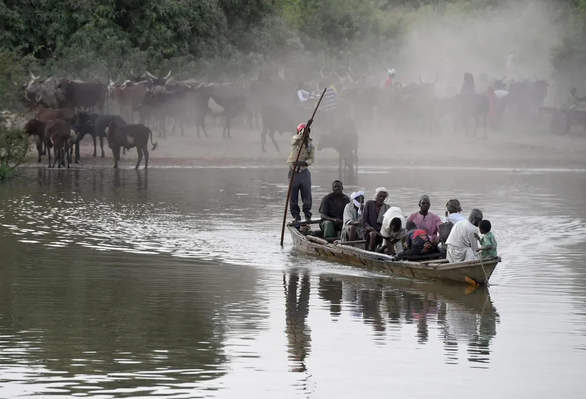 People cross a section of Lake Chad—whose waters border Niger, Nigeria, and Cameroon—at the village of Guite, north of N’Djamena City, Chad's capital, on March 30, 2015. (Philippe Desmazes/AFP/Getty Images)
