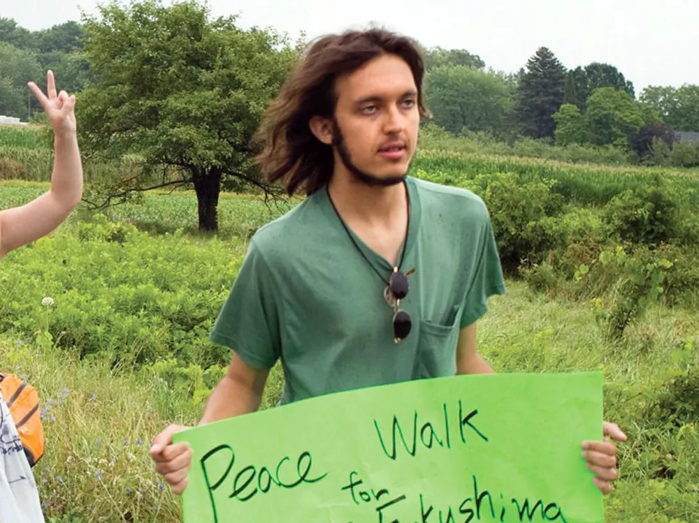 In this July 26, 2012 photo provided by the Northumberland News, Alexander Ciccolo participates in a peace walk through Brighton, Ontario. Law enforcement officials say Ciccolo was arrested after his father, a Boston police captain, alerted authorities that his son was talking about joining the Islamic State group and setting off bombs. (Dave Fraser/Northumberland News via AP)