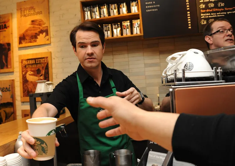 Jimmy Car hands a customer a new stronger British Latte at Starbucks on March 14, 2012 in London, England. (Stuart Wilson/Getty Images)