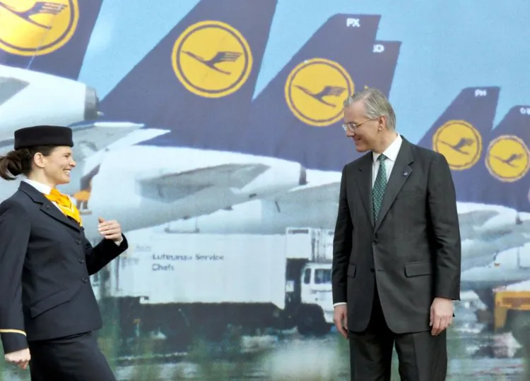 German airline Lufthansa's CEO Christoph Franz poses for photographers with a cabin crew member during the results press conference in the central German city of Frankfurt am Main on March 15, 2012. (Boris Roessler/AFP/Getty Images)