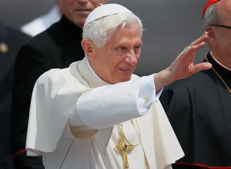 Pope Benedict XVI (2nd R) waves as he walks to his car during a welcoming ceremony after arriving at the Jose Marti International airport on the second day of his three-day visit on March 27, 2012 in Havana (Joe Raedle/Getty Images)