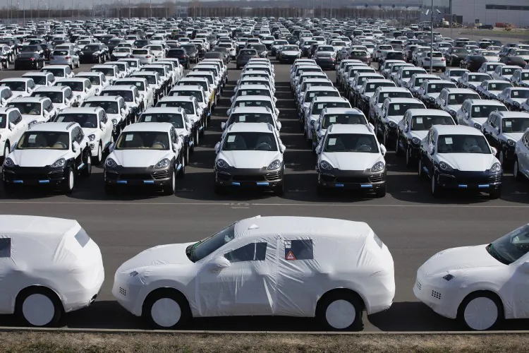 Freshly assembled Porsche Cayenne SUVs line a parking lot before shipping at the Porsche factory in Leipzig, Germany, on March 28. (Sean Gallup/Getty Images)