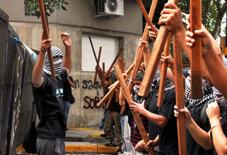 Members of Quebracho political group demonstrate in front of the fences that block their way to the British embassy in Buenos Aires on April 2, 2012. (Daniel Garcia/AFP/Getty Images)