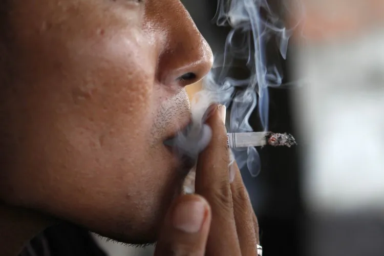 A man exhales smoke from his cigarette. (OSCAR SIAGIAN/AFP/Getty Images)