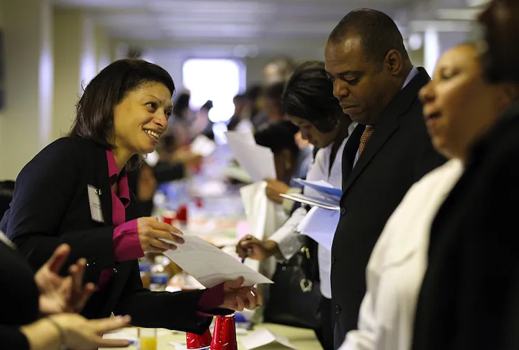A job seeker meets with a recruiter during a job fair hosted by the State of New York at the Shirley A. Chisholm State Office Building on April 12, 2012 in Brooklyn, New York. (Justin Sullivan/Getty Images)