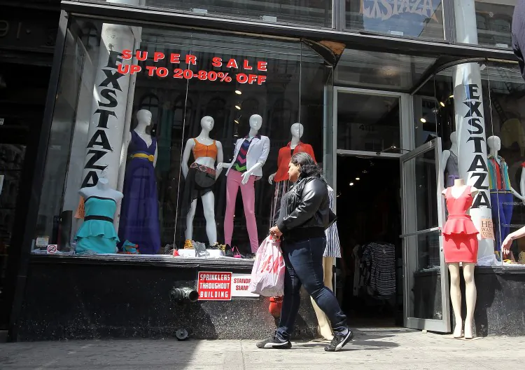 A pedestrian stops to window shop at a store on April 16 in New York City. According to a Bank of Montreal report, cross-border shopping will be pervasive this summer despite the smaller Canada-U.S. price gap. (Justin Sullivan/Getty Images)