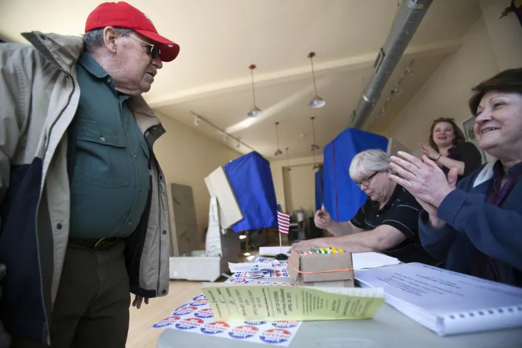 Election workers greet a voter as he enters during the Republican primary election April 24 at Northern Liberties Neighbors Association in Philadelphia. (Jessica Kourkounis/Getty Images)