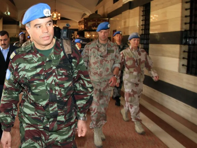 Colonel Ahmed Himmiche (L), Chief of UN observers in Syria, leaves his hotel in Damascus with his team to patrol flashpoint areas in the unrest-stricken country on April 25. (Louai Beshara/AFP/Getty Images)