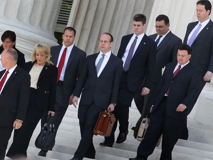 Arizona Gov. Jan Brewer (3rd L) and her legal team walk away after arguments at the U.S. Supreme Court on April 25 in Washington, D.C. Before S.B. 1070 could be enforced, the federal government went to court to block the law, arguing that the state law would pre-empt federal immigrations laws, and the lower courts agreed. (Mark Wilson/Getty Images)