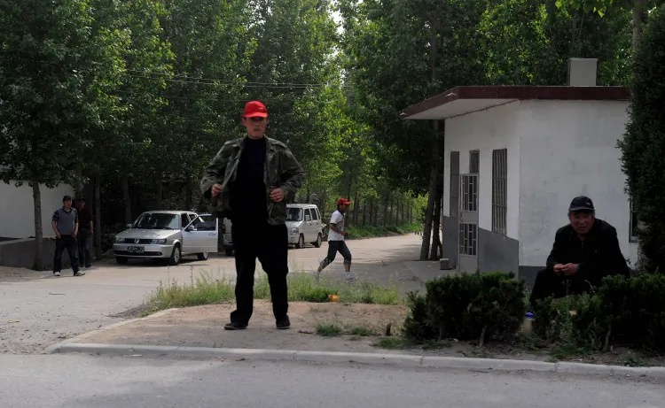 Plainclothes security monitor the entrance to Dongshigu Village, in Shandong Province on April 28, where blind activist Chen Guangcheng lives. More than US$31.6 million has been spent since 2008 to monitor Chen and his family. (Mark Ralston/AFP/GettyImages)