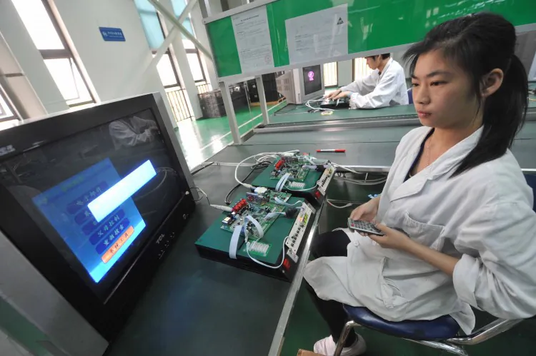 Chinese workers test the circuit boards at a factory in Mianyang, southwest China's Sichuan province on April 30, 2012 (STR/AFP/Getty Images)