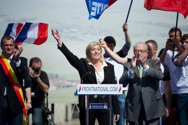 French far right party Front National (FN) former presidential candidate Marine Le Pen (C) waves as she arrives to give a speech during the FN's annual celebration on May 1, 2012. (Bertrand Langlois/AFP/GettyImages)