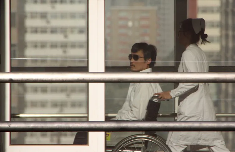 Chinese activist activist Chen Guangcheng is pushed in a wheelchair by a nurse at the Chaoyang hospital in Beijing on May 2, 2012. He agreed to leave U.S. care after receiving promises of safety by the Chinese regime. (Jordan Pouille/AFP/GettyImages)