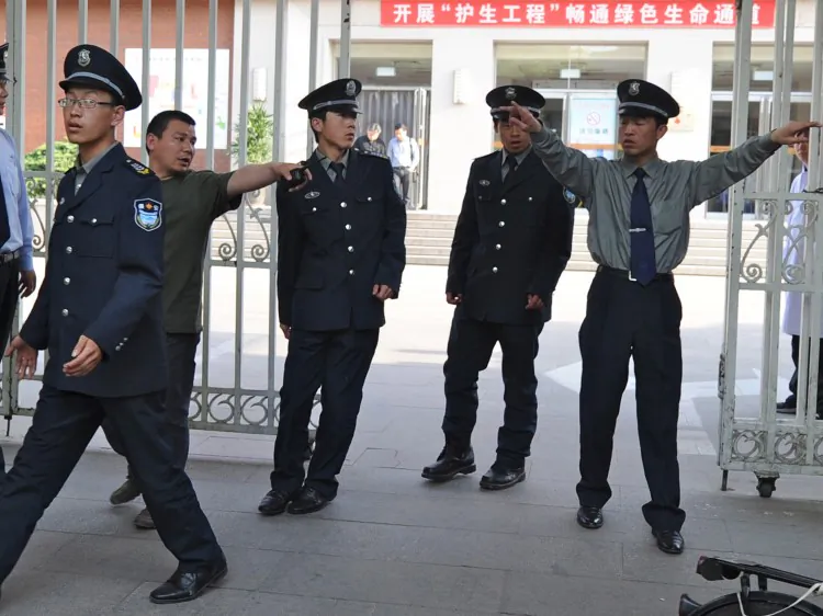 Security police prepare to evict reporters trying to see blind rights activist Chen Guangcheng at the Chaoyang Hospital where Chen is receiving treatment, in Beijing on May 2. (AFP/GettyImages)