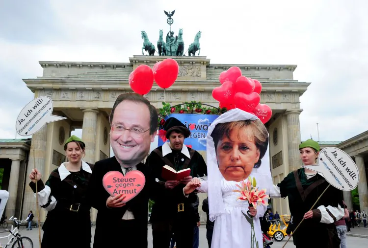 Activists wear masks featuring German chancellor Angela Merkel (2nd R) and incoming French Socialist President François Hollande (2nd L) as they perform a fake marriage in front of the Brandenburg Gate in Berlin, on May 7. (John Macdougall/AFP/GettyImages)