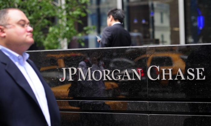 People walk past JP Morgan Chase Co headquarters in New York, May 14. 2015. (Emmanuel Dunand/AFP/GettyImages)