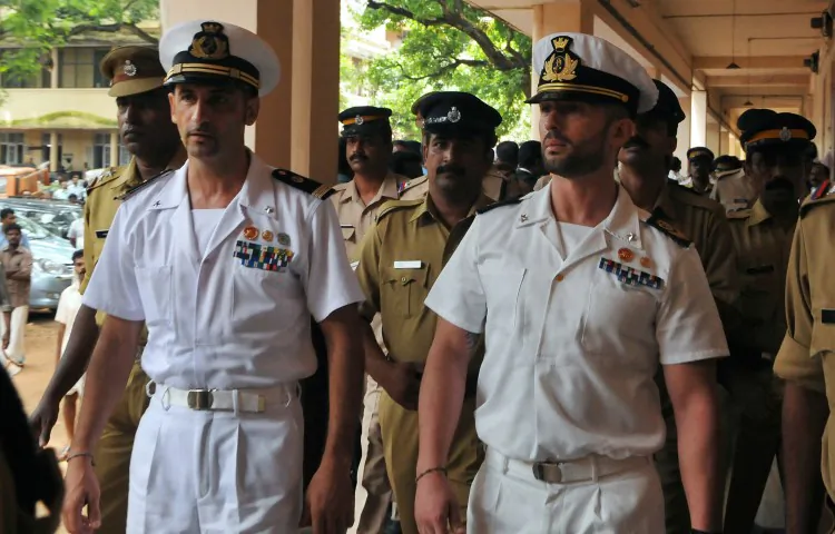 Italian marines Latore Massimiliano (2L) and Salvatore Girone (2R) are escorted by Indian police outside a court in Kerala, India on May 25, 2012. (STRDEL/AFP/GettyImages)