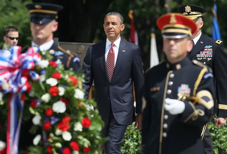 U.S. President Barack Obama (C) walks up to lay a commemorative wreath during a ceremony on Memorial Day at the Tomb of the Unknowns at Arlington National Cemetery on May 28, 2012 in Arlington, Virginia. For Memorial Day President Obama is paying tribute to military veterans past and present who have served and sacrificed their lives for their country. (Mark Wilson/Getty Images)