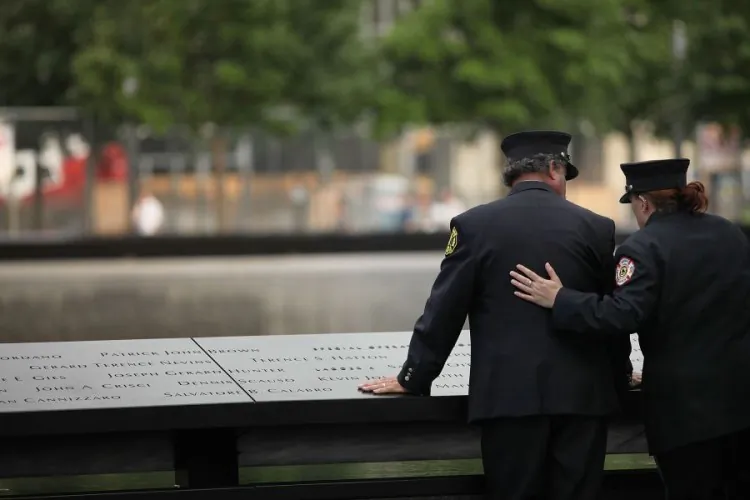 Ten years after the formal end to the Ground Zero cleanup efforts, workers pay tribute to the thousands of men and women who sacrificed their lives and their health to contain and clean up the debris left by the 9/11 attacks. (Spencer Platt/Getty Images)