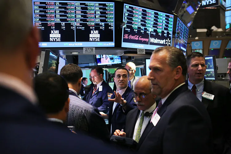 Traders work on the floor of the New York Stock Exchange on June 6. As investors gained confidence that more stimulus for the global economy U.S. stocks rallied with the Dow and S&P 500 showing their best gains of the year. (Spencer Platt/Getty Images)