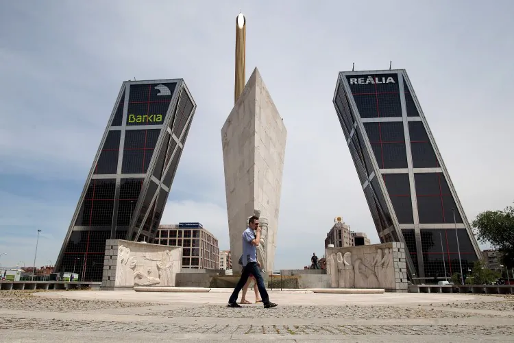 A man walks near the Kio Towers, headquarters of Spanish banking giant Bankia in Plaza de Castilla on June 9 in Madrid, Spain. (Pablo Blazquez Dominguez/Getty Images)