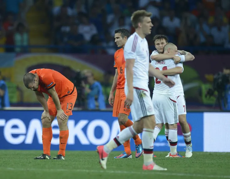 Denmark players celebrate Euro 2012’s first major upset after beating Netherlands on Saturday in Ukraine. (Filippo Monteforte/AFP/GettyImages)