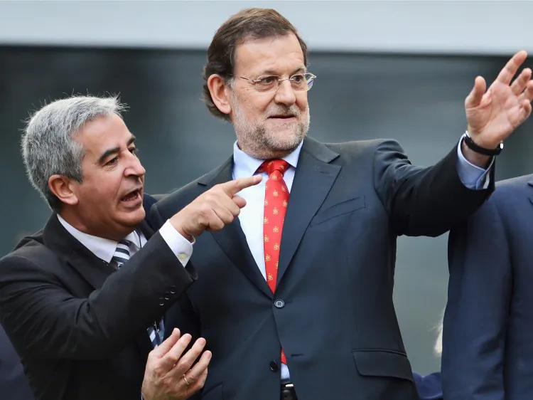 Spanish Prime Minister Mariano Rajoy (R) is seen at the UEFA EURO 2012 group C match between Spain and Italy in Gdansk, Poland. An independent study last week found that Spanish banks would need collective capital of between $64 billion and $77 billion. (Jasper Juinen/Getty Images)