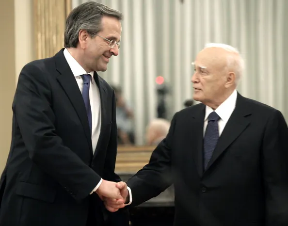 Newly appointed Greek Prime Minister Antonis Samaras (L) shakes hands with President Karolos Papoulias after Samara was sworn in at the presidential palace, June 20, 2012 in Athens, Greece. (Milos Bicanski/Getty Images)