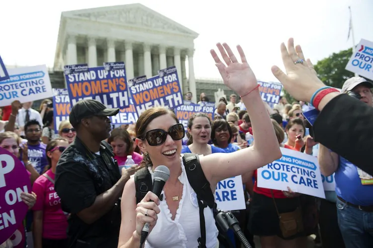 Angela Botticella (C) of "Know Your Care Support Your Care" celebrates with a supporter of US President Barack Obama's signature healthcare legislation as they celebrate after the US Supreme Court upheld the constitutionality of the Affordable Healthcare Act, outside the Supreme Court in Washington, DC, June 28, 2012. (Saul Loeb/AFP/Getty Images)