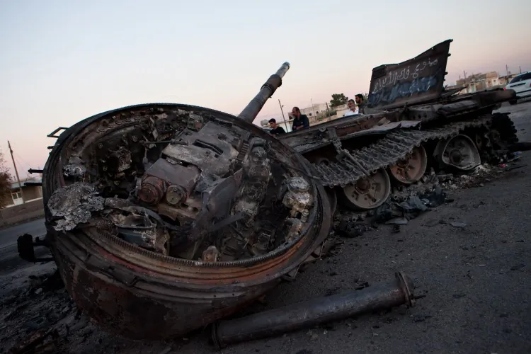 A destroyed Syrian army tank is abandoned after fighting with rebels, on the side of a highway between Aleppo and Damascus in Khan-al Sible, village of Idlib province, on July 4, 2012. (Lo/AFP/GettyImages)