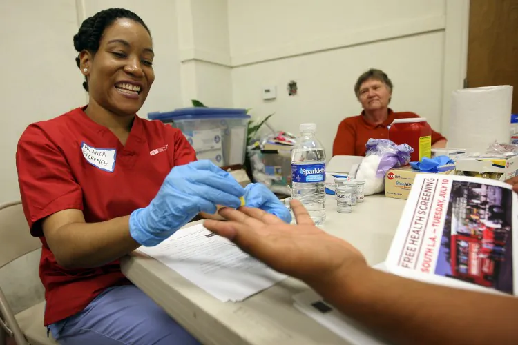 UCLA nurse Rolanda Florence checks a man's blood sugar in Los Angeles as nurses and physicians give free health screenings in this file photo from July 10. (David McNew/Getty Images)