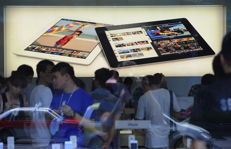 Customers flock to an Apple store where the latest version of the Apple iPad went on sale in Apple stores in Shanghai on July 20, 2012. (Peter Parks/AFP/Getty Images)