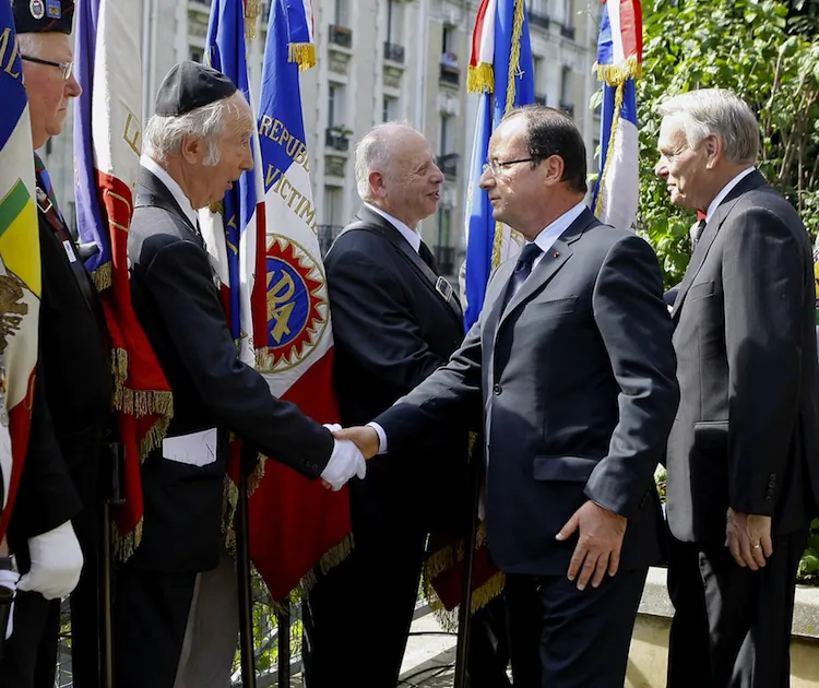 French Interior Minister Manuel Valls (L) unveils a plaque dedicated to the "Righteous among the Nations" ("Justes parmi les nations" in French) for their efforts to save Jews from the Nazis during World War II, on July 22, 2012 in the center of Strasbourg, eastern France, as part of a ceremony to commemorate the seventieth anniversary of the Vel D'Hiv roundup (Rafle du Velodrome d'Hiver). (Patrick Hertzog/AFP/Getty Images)