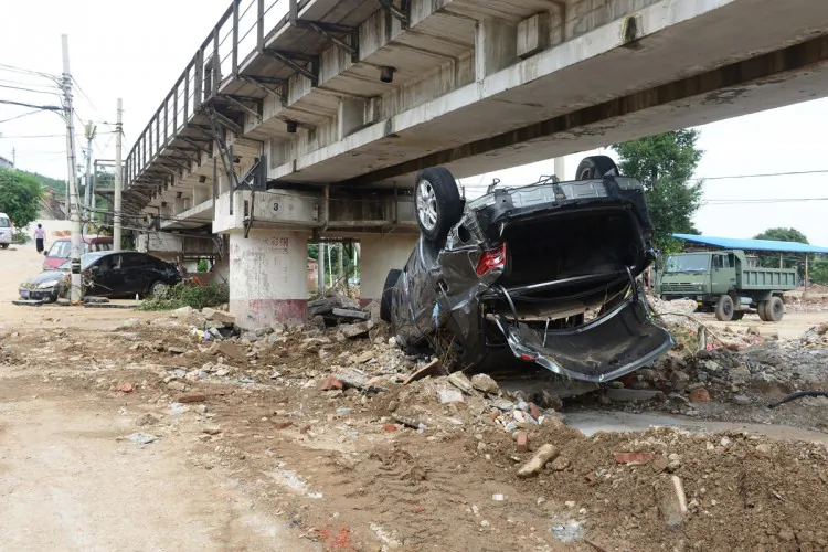 This picture taken on July 23, 2012 shows damaged cars along a street after heavy rains in Beijing. (AFP/AFP/GettyImages)