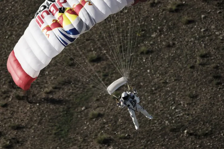 Pilot Felix Baumgartner of Austria lands in the desert during the second manned test flight for Red Bull Stratos in Roswell, New Mexico, USA on July 25, 2012. Baumgartner called off his most recent skydive due to unpredictable winds. (Joerg Mitter/Red Bull via Getty Images)