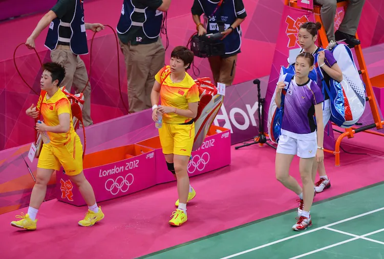 Wang Xiaoli and Yang Yu of China leave the court with Ha Na Kim and Kyung Eun Jung of Korea after their Women's Doubles Badminton on Day 4 of the London 2012 Olympic Games at Wembley Arena on July 31, 2012 in London, England. (Michael Regan/Getty Images)