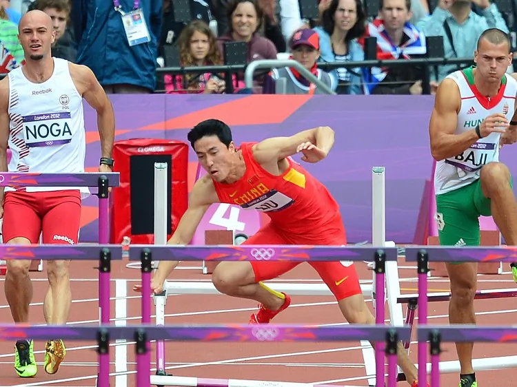 China's Liu Xiang (C) falls at the preliminaries for the men's 110-meter hurdles at the 2012 London Olympics on Aug. 7. Liu suffered an injury to his right Achilles tendon, which he also injured in the 2008 Olympics. (Gabriel Bouys/AFP/GettyImages)