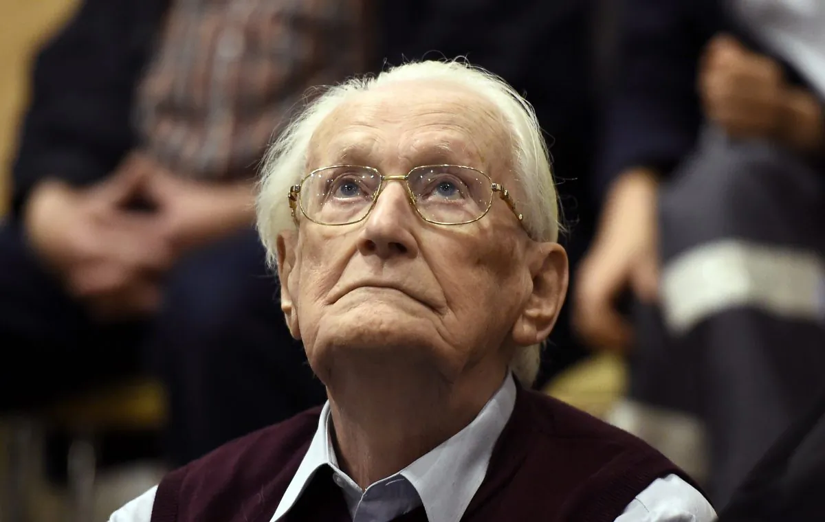 94-year-old former SS sergeant Oskar Groening looks up as he listens to the verdict of his trial Wednesday, July 15, 2015 at a court in Lueneburg, northern Germany. Groening, who served at the Auschwitz death camp was convicted on 300,000 counts of accessory to murder and given a four-year sentence. (Tobias Schwarz/Pool Photo via AP)