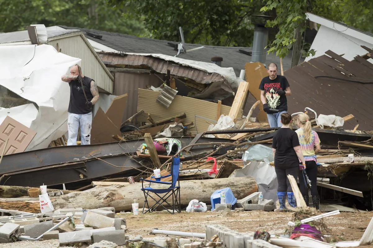 Residents of a mobile home park look for belongings after deadly flooding in Flat Gap, Ky., Tuesday, July 14, 2015. (AP Photo/David Stephenson)