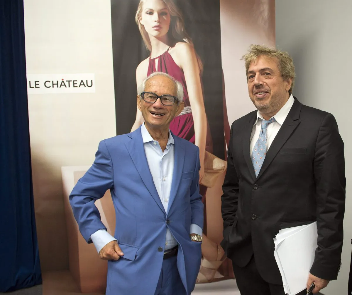 Le Chateau founder and director Herschel Segal (L) chats with Franco Rocchi, senior vice-president of sales and operations, after the company’s annual meeting in Montreal on July 15, 2015. (The Canadian Press/Ryan Remiorz)