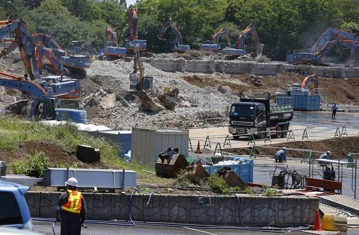 In this May 13, 2015 file photo, Japan's National Stadium is dismantled for the renovation for the 2020 Tokyo Olympic Games, in Tokyo. (AP Photo/Shizuo Kambayashi)