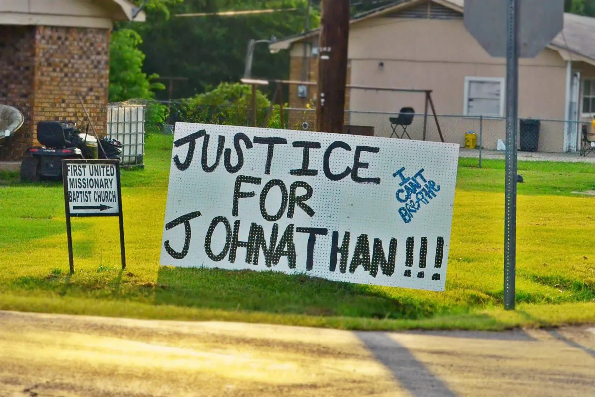 In this July 11, 2015 photograph, sign of support for Jonathan Sanders, a black man who is believed to have died after a physical encounter with a white police officer, hangs on a corner in Stonewall, Miss. (Jennifer Bozeman/The Clarke County Tribune, via AP)