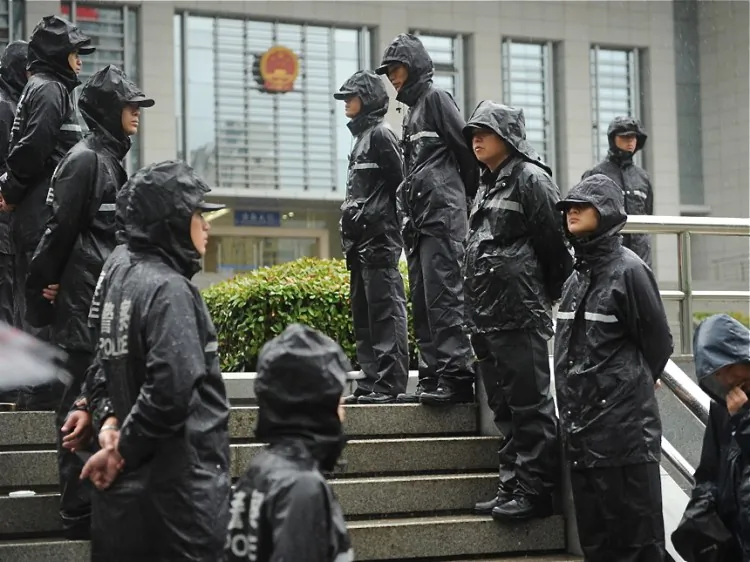 Police on guard outside the Intermediate People's Court in Hefei, Anhui Province, on Aug. 9. The court opens China's highest-profile trial in decades as the wife of the disgraced Chinese politician Bo Xilai faces charges of murdering British businessman Neil Heywood. (Peter Parks/AFP/Getty Images)