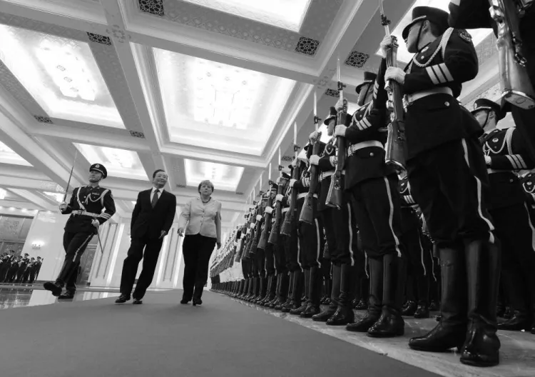 German Chancellor Angela Merkel (C) and Chinese Premier Wen Jiabao review an honor guard during her welcoming ceremony at the Great Hall of the People in Beijing on August 30, 2012. (Mark Ralston/AFP/GettyImages)